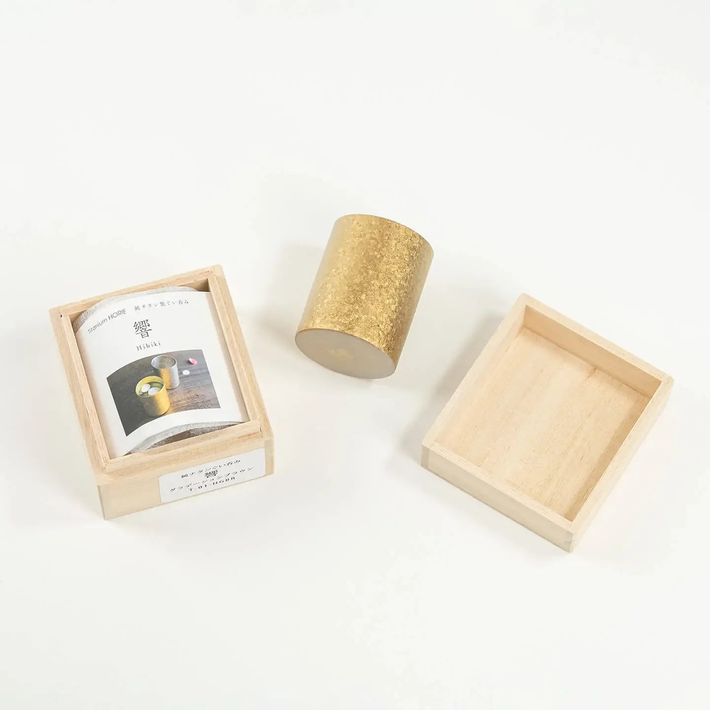 An alternate view of the HORIE Titanium Sake Cup packaging, showing the cup and box.