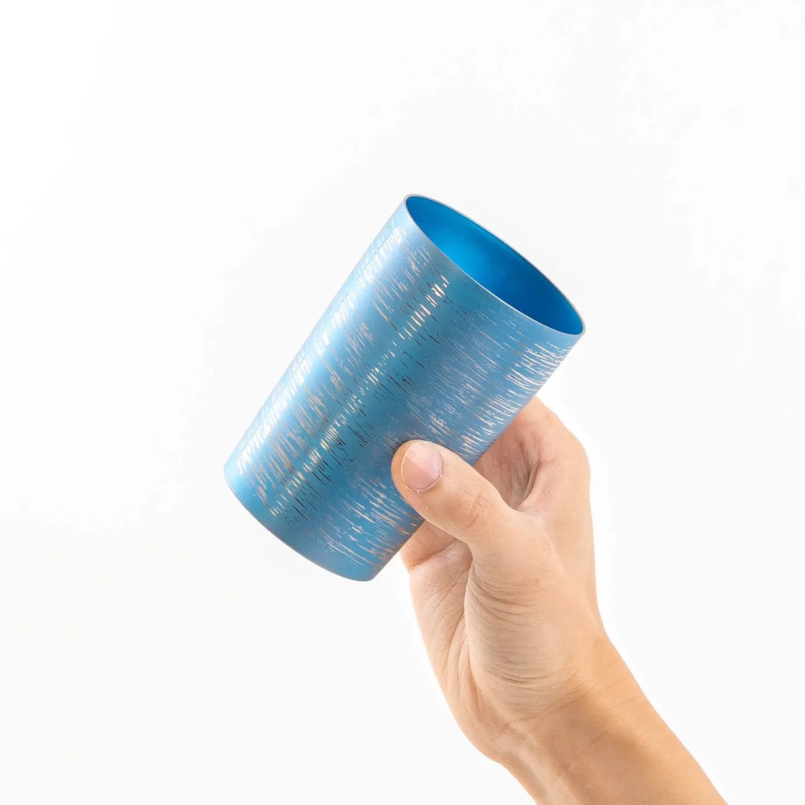 Insulated titanium tumbler 270ml blue, tilted in hand, HORIE Shirakaba Series