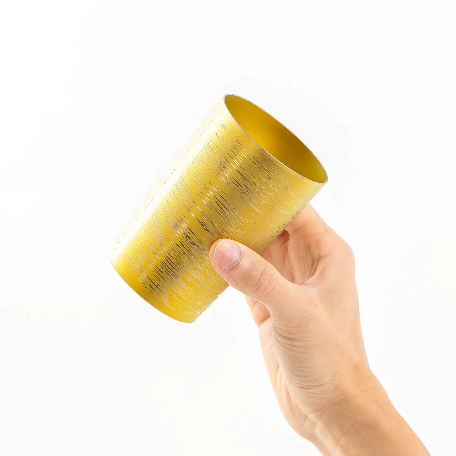 Insulated titanium tumbler 270ml gold, tilted in hand, HORIE Shirakaba Series
