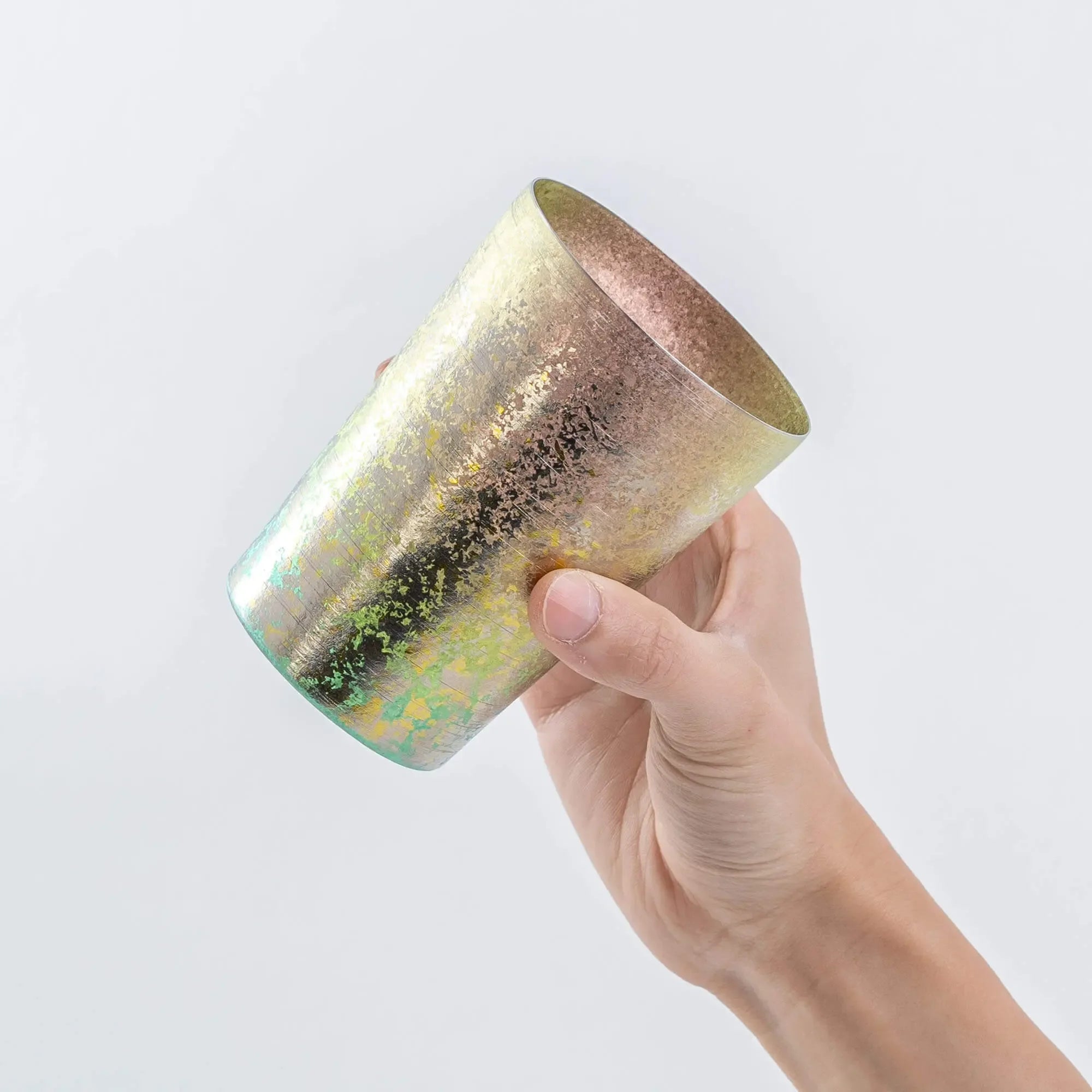 Side view of pink HORIE tumbler in hand