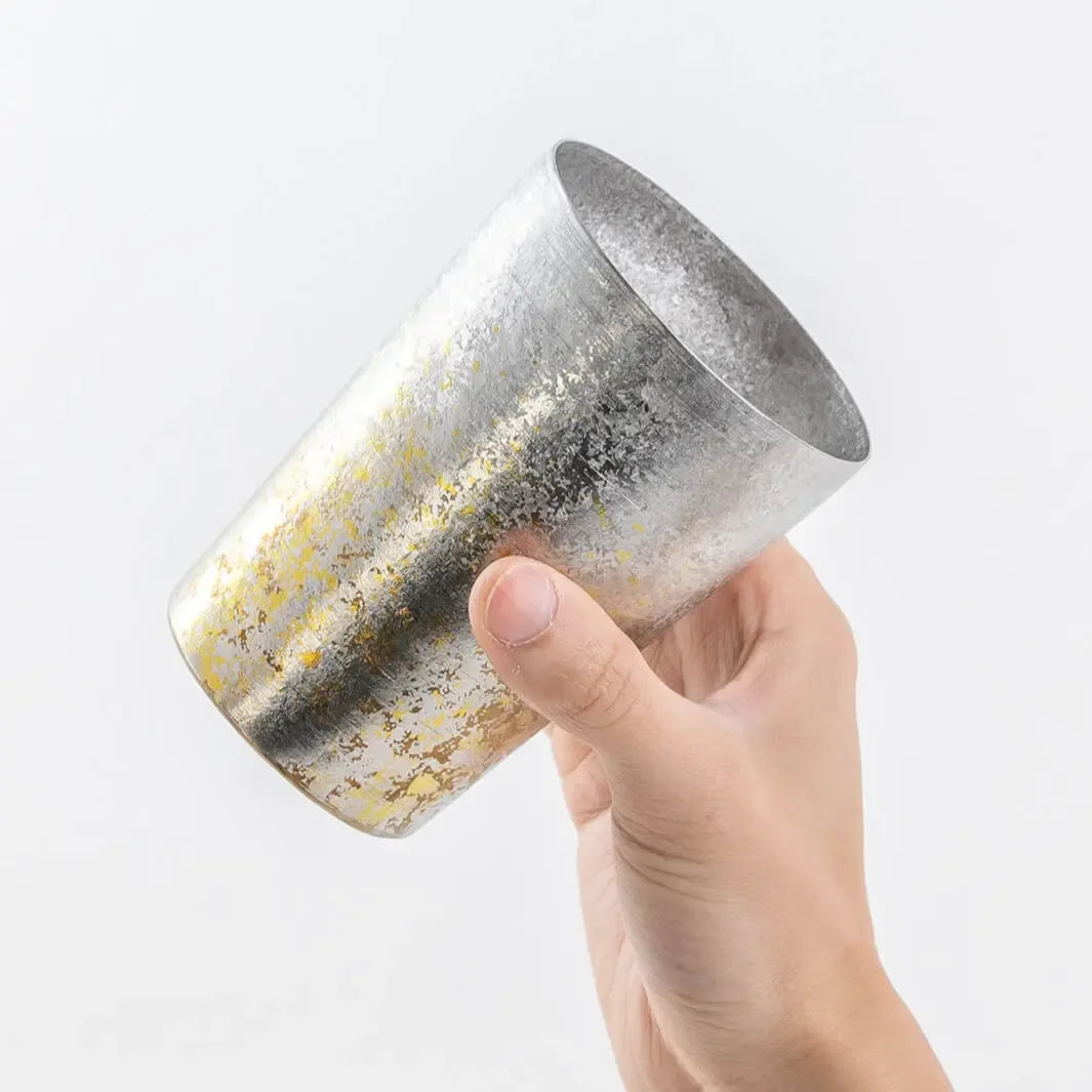 Side view of silver HORIE tumbler in hand