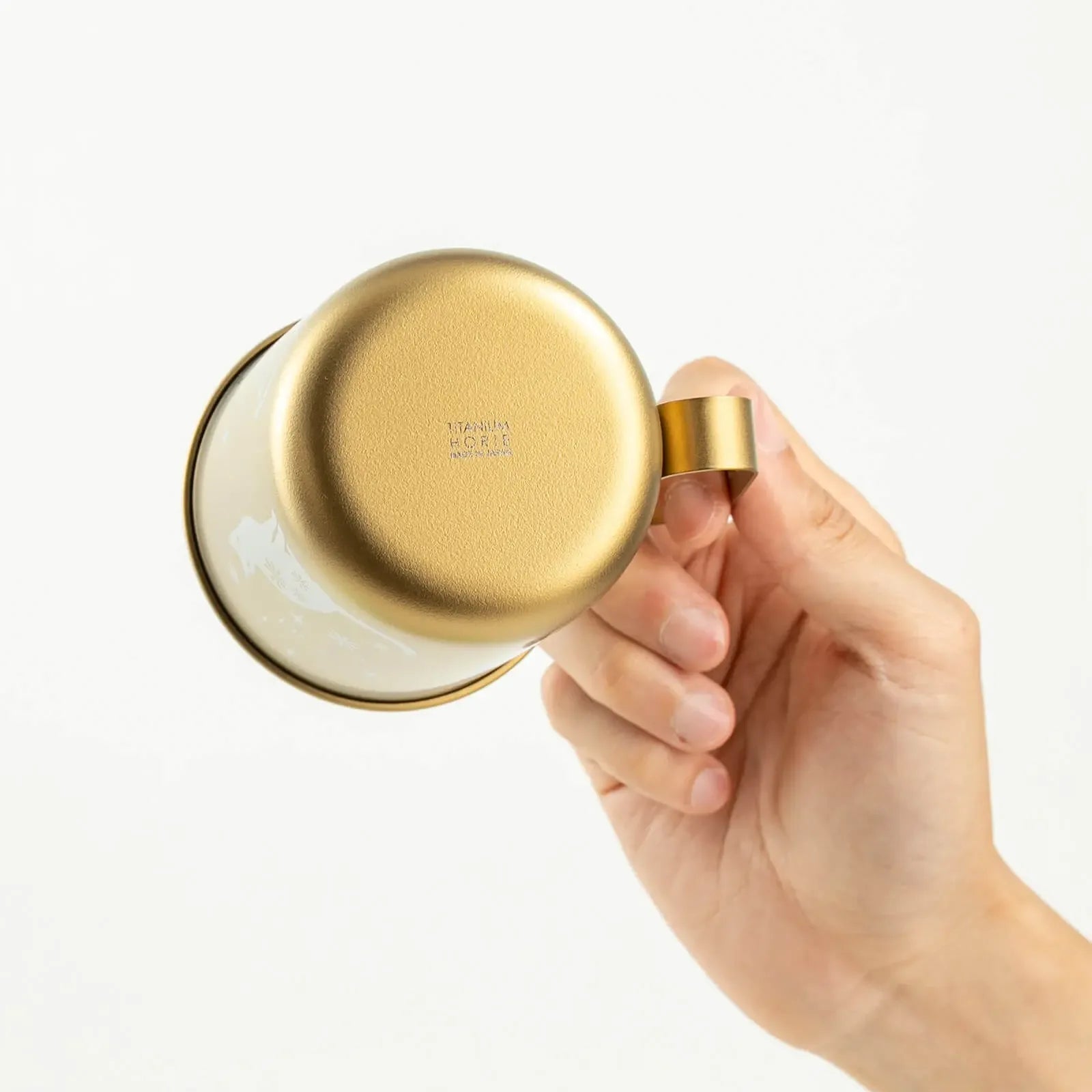 Bottom of mug with HORIE logo in hand