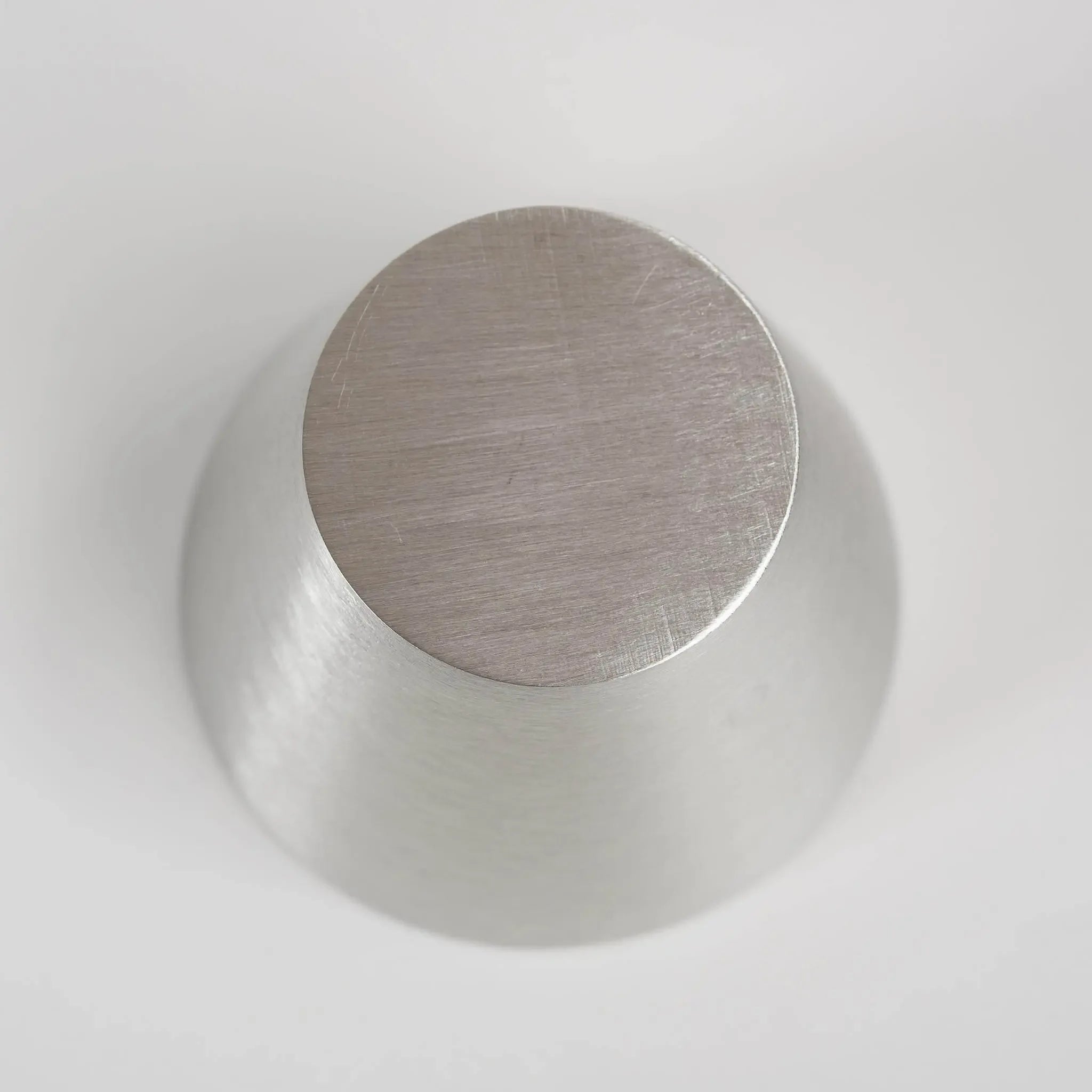 Bottom view of the authentic Nousaku tin cup showing the brand craftsmanship.