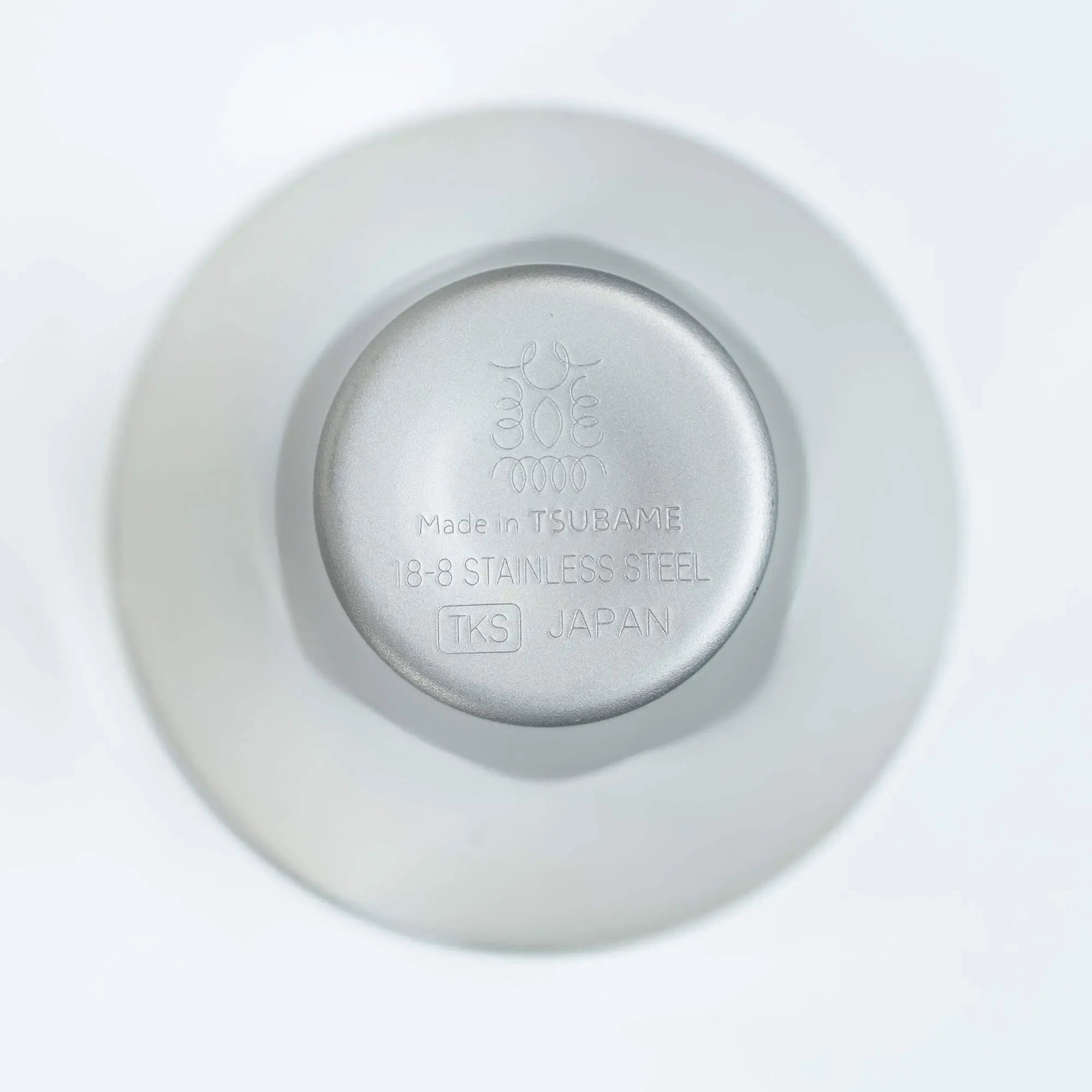 Sake cup bottom with engraved brand logo, stainless steel design