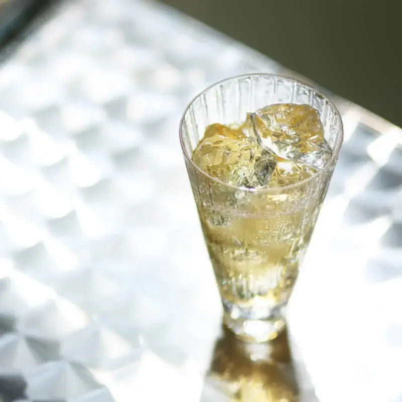 top view of suntory x sghr crafe whiskey glass with whiskey and ice