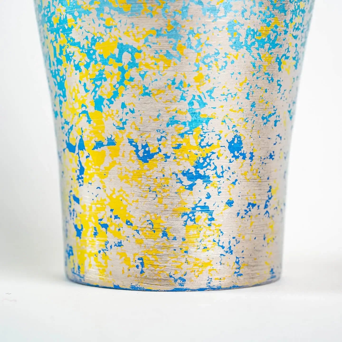 Close-up of lower surface texture on blue titanium tumbler