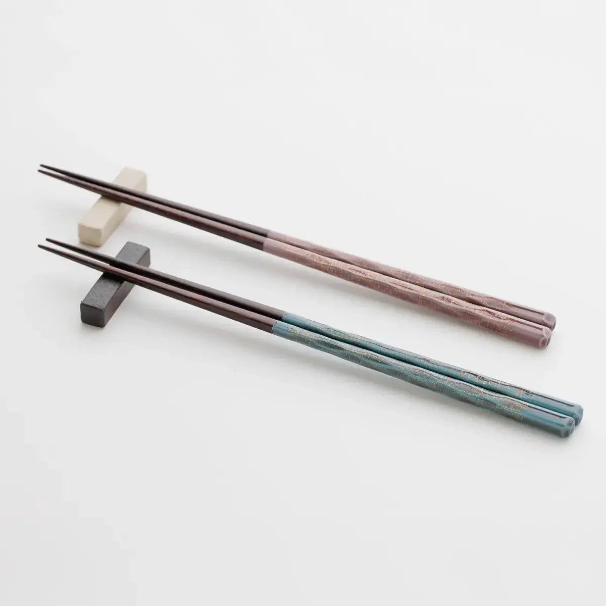 A pair of Wakasa lacquer chopsticks resting elegantly on a chopstick holder.