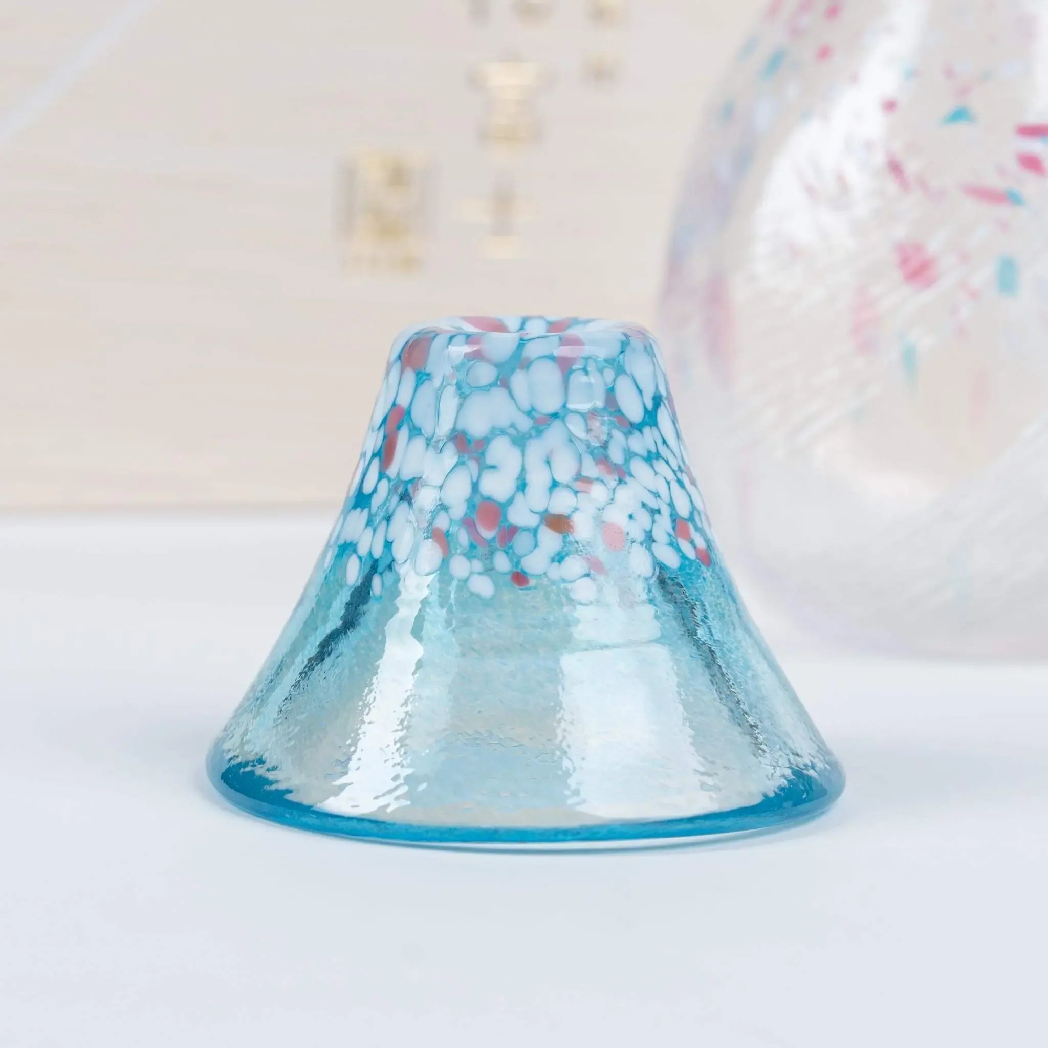 Handmade Japanese sake cup in blue, inspired by cherry blossoms and Mount Fuji, unique glass texture