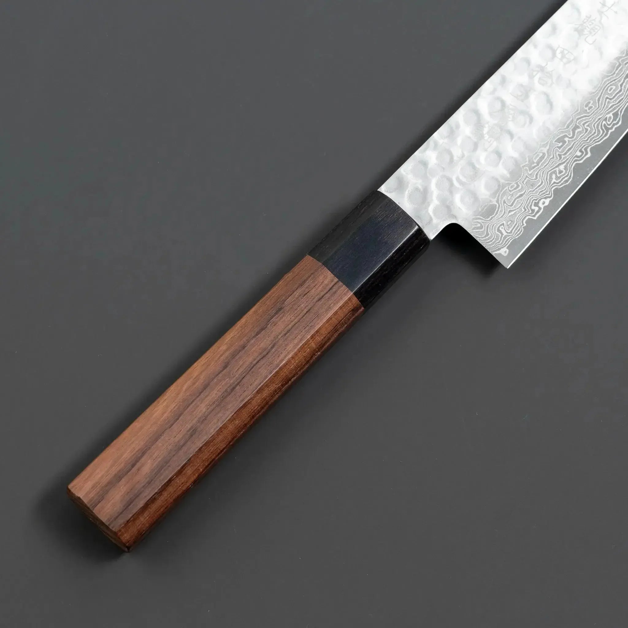 Fujikan Aus-10 Damascus Steel Gyuto Knife with ergonomic handle and razor-sharp edge for professional chefs