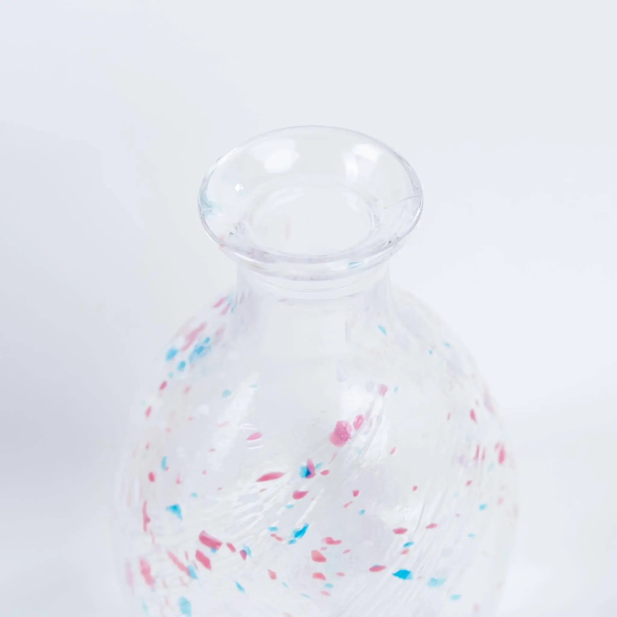 Detail of handmade Japanese sake bottle showing delicate glass craftsmanship and smooth pouring design