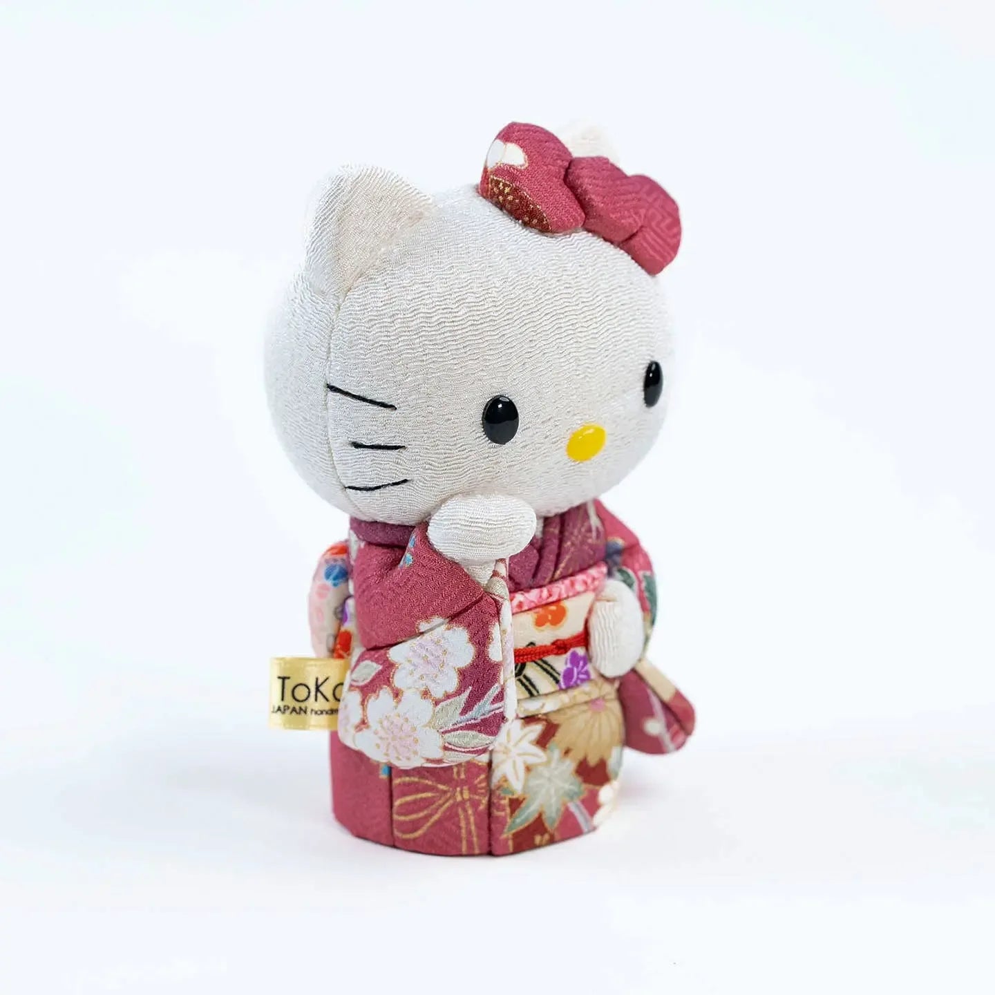 Angled view of the Hello Kitty Maneki Neko (lucky cat) doll on a white background.