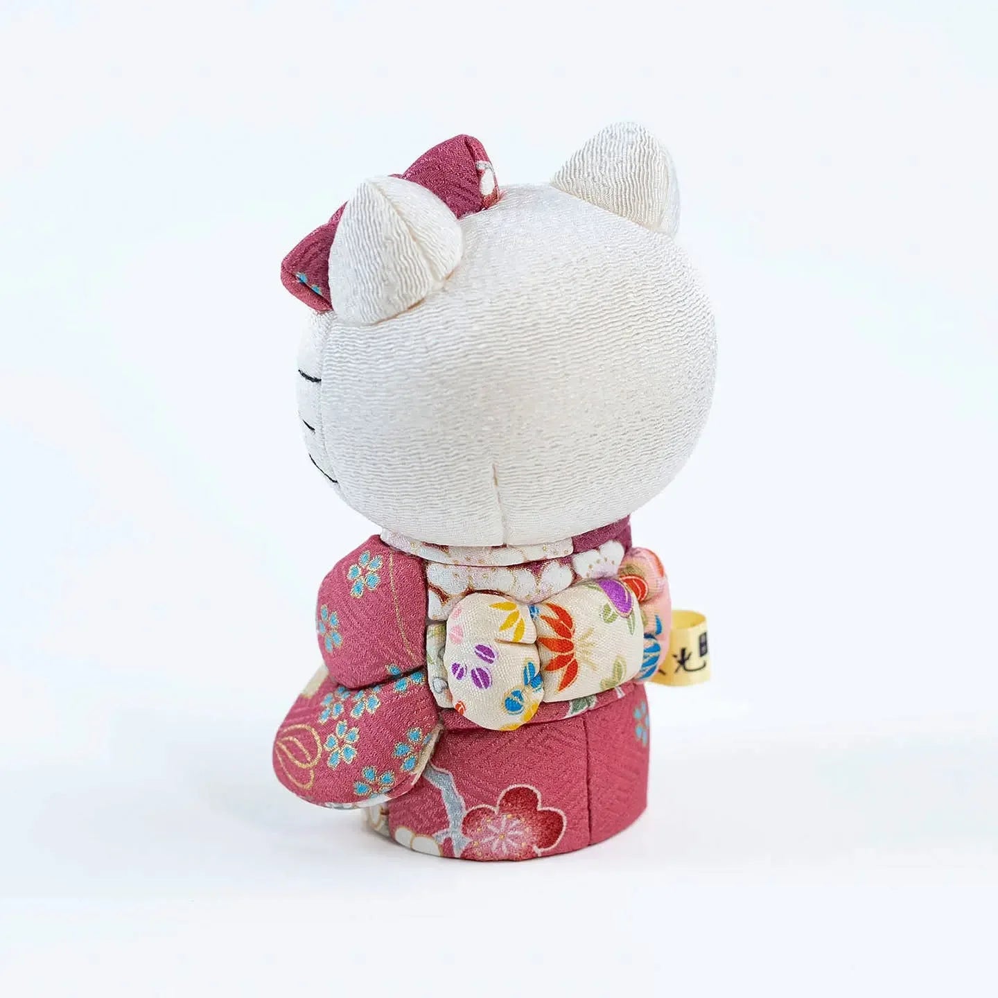 Back view of the Hello Kitty doll, showcasing the craftsmanship of the pink kimono's obi sash.