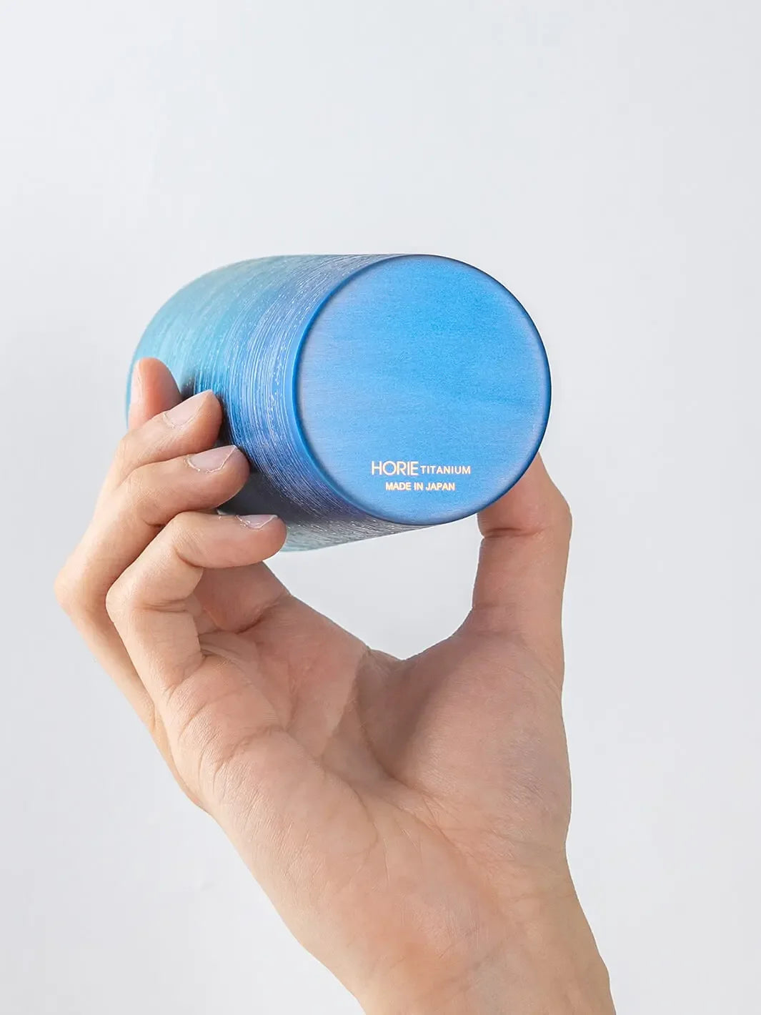 Bottom of HORIE Ryo Ocean Blue tumbler (350ml) held in hand, showing engraved base