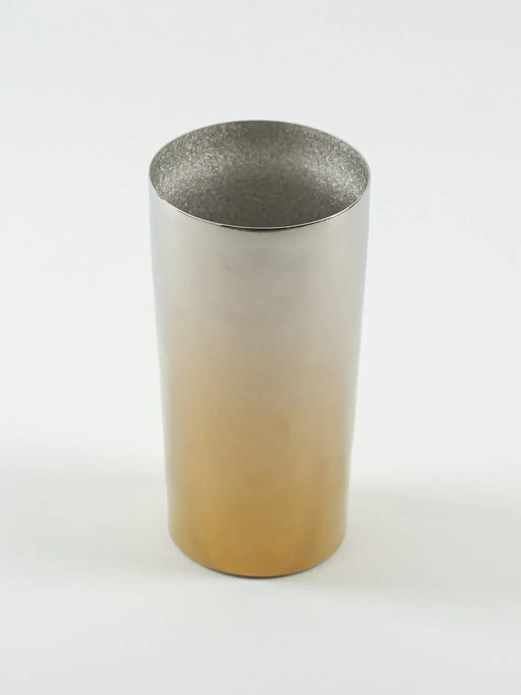Top-angled view of HORIE Saiko gold-silver titanium tumbler (350ml), showing metallic sheen