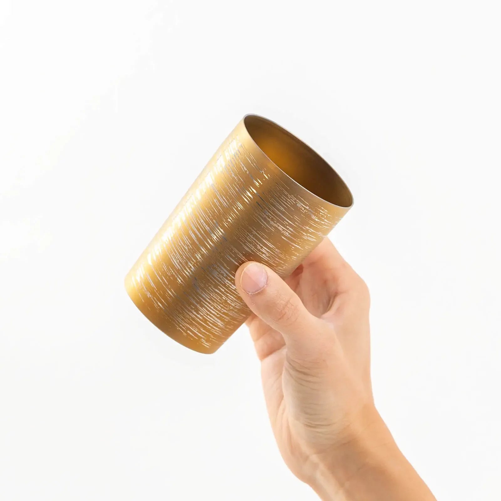 Insulated titanium tumbler 270ml brown, tilted in hand, HORIE Shirakaba Series