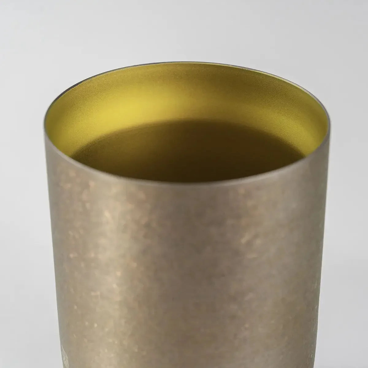 Close-up of the gold finish on the HORIE Zen Series 400ml Double-Walled Titanium Tumbler, emphasizing its durable and premium material.