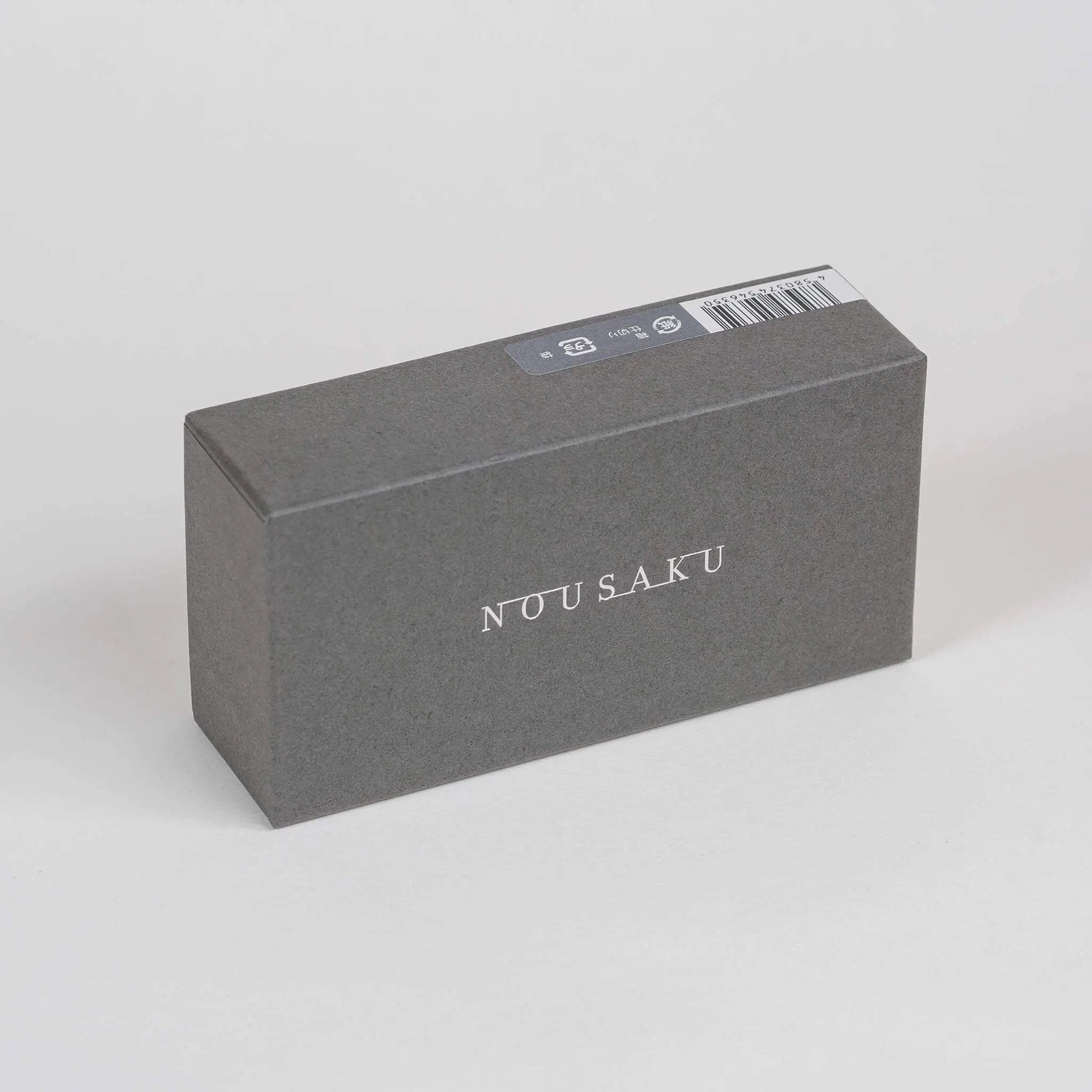 The sophisticated and minimalist outer packaging box for the Nousaku Rocking Sake Cup Set.