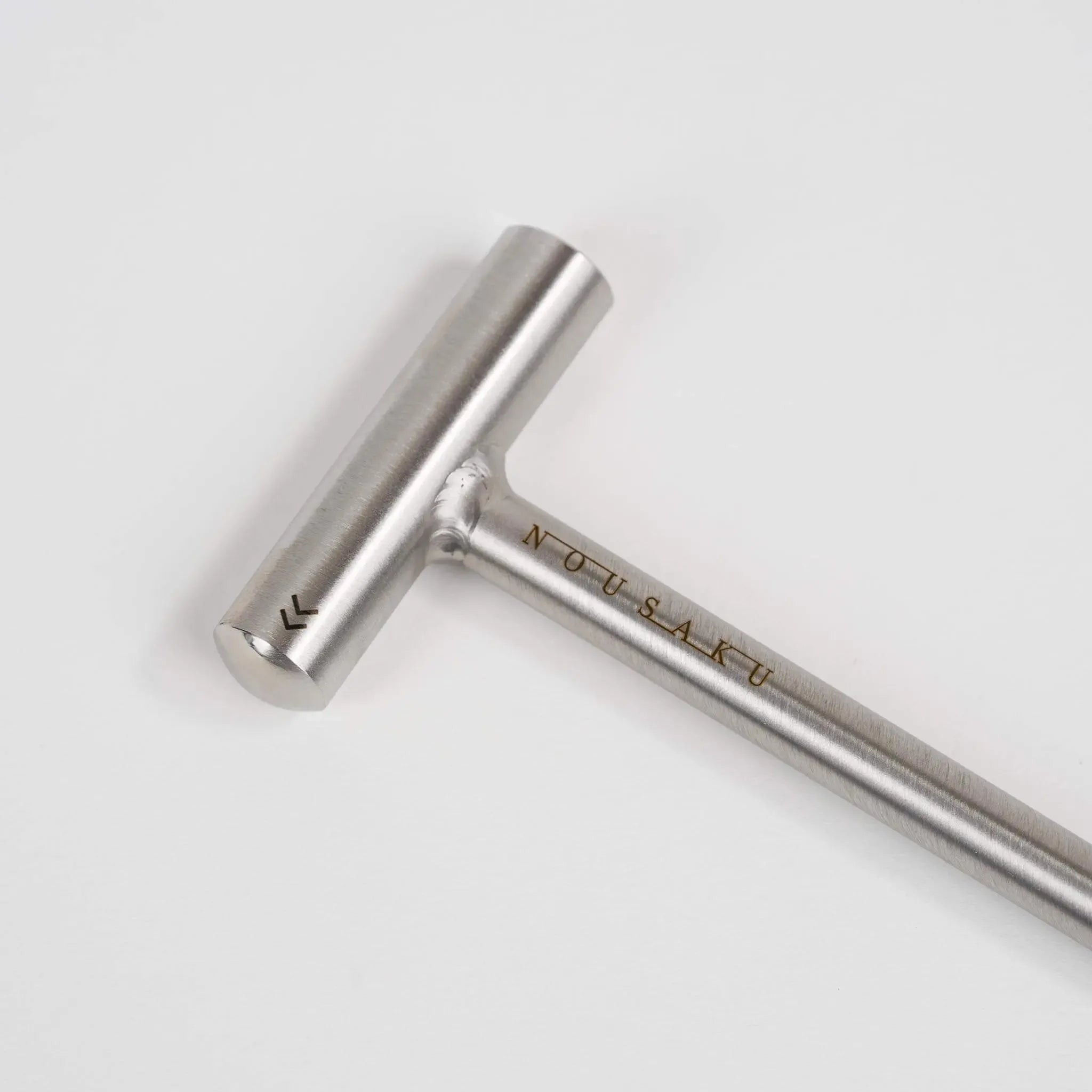 Detailed view of the stainless steel hammer included in the Nousaku DIY kit.