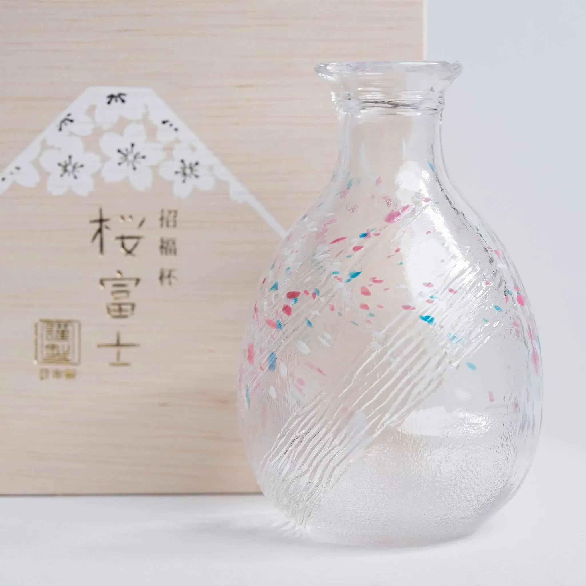 Handmade Japanese sake bottle with sakura and Mount Fuji motif, elegant glass design made in Japan.