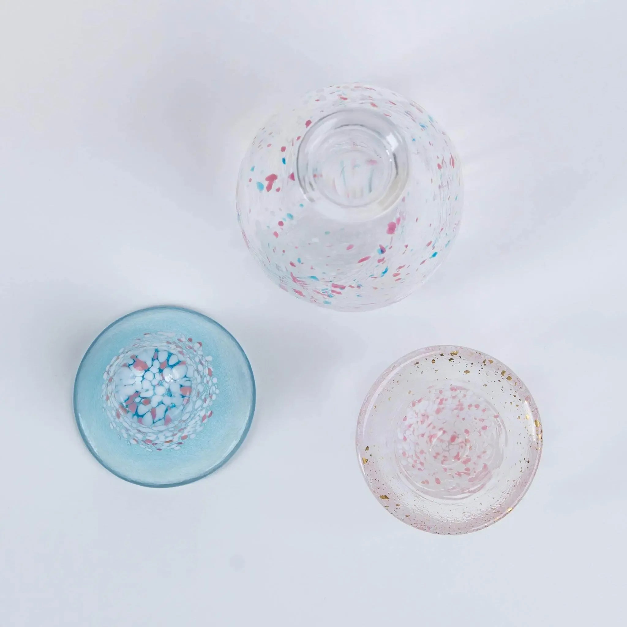 Top view of handmade Japanese sake set with sakura and Mount Fuji design, glass bottle and cups made in Japan.