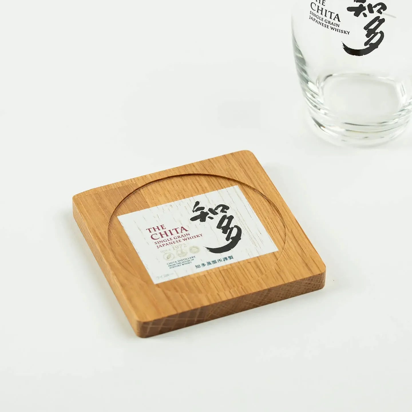The square The Chita cask oak coaster, featuring the classic Japanese single grain whisky label design.