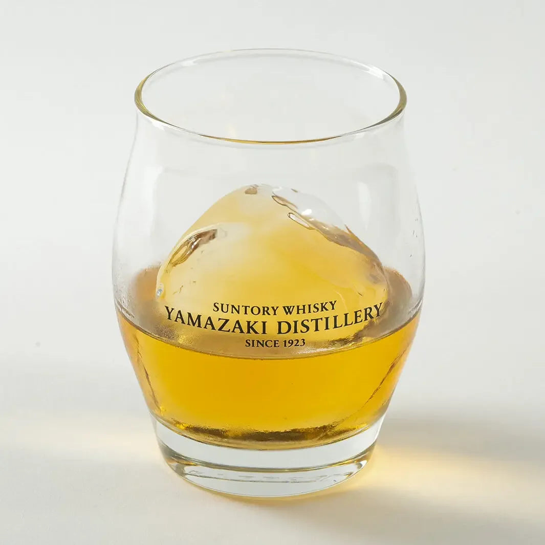 Angled view of Yamazaki ice ball whiskey glass with whisky and ice